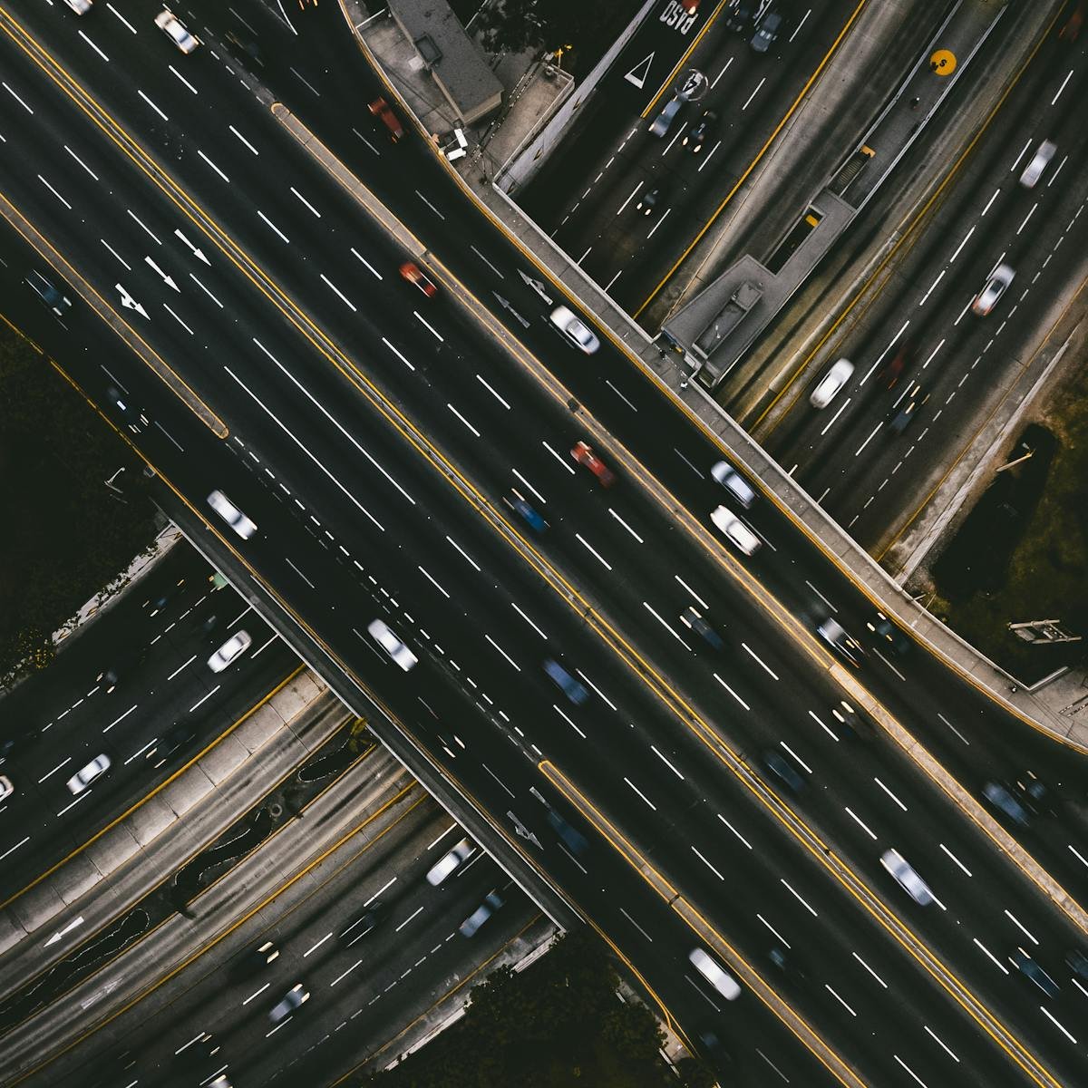 Highway intersection in Lima, Peru, showcasing urban traffic from a drone perspective.