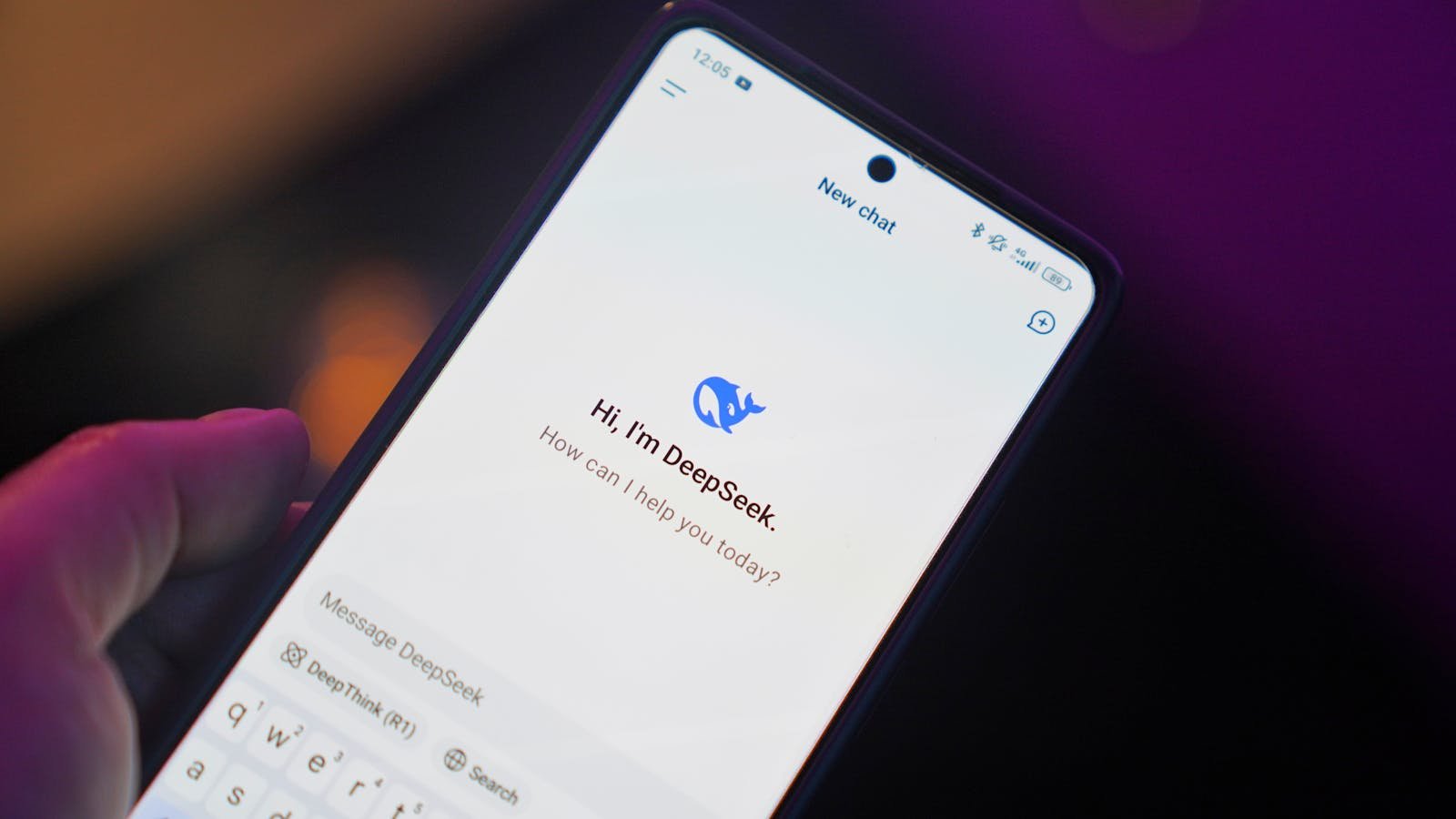 Close-up of a smartphone showing AI chat interface with digital assistant DeepSeek.